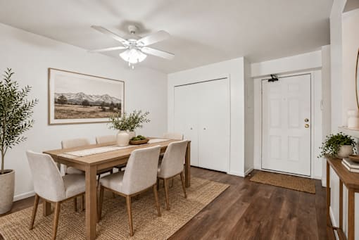 A dining room with a wooden table and chairs.