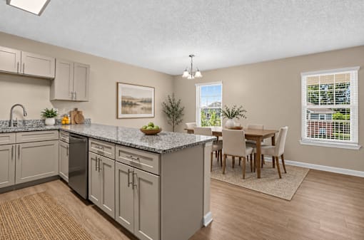 A kitchen with a dining table and chairs.