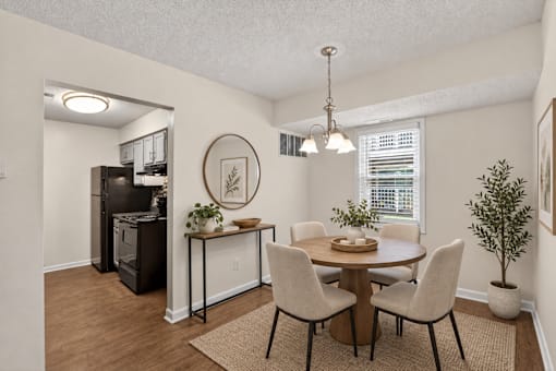 A dining room with a table set for four.