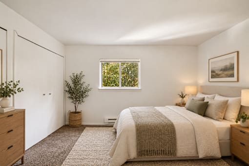 A bedroom with a large bed and a window.