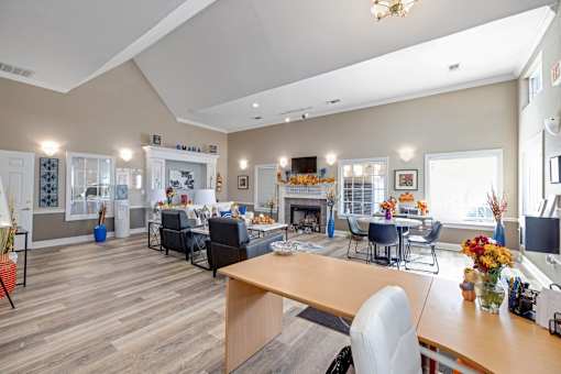 Well-lit clubhouse room with fireplace and dining area at Cambury Hills Apartments in Omaha, Nebraska