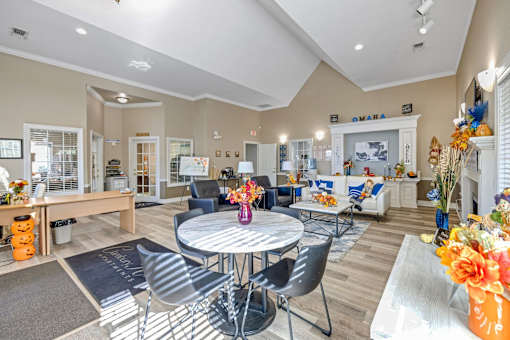 Bright community room with white table and chairs at Cambury Hills Apartments in Omaha, Nebraska