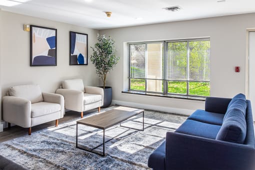 a living room with couches and chairs and a coffee table