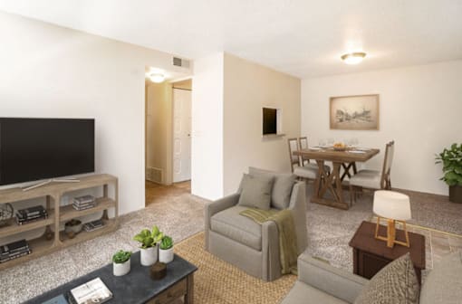 A living room with a grey couch, a wooden coffee table, and a television.
