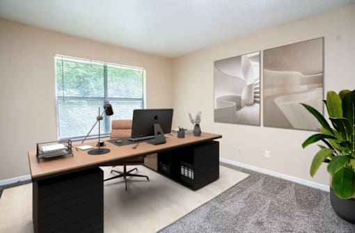A home office with a desk, chair, and computer setup.