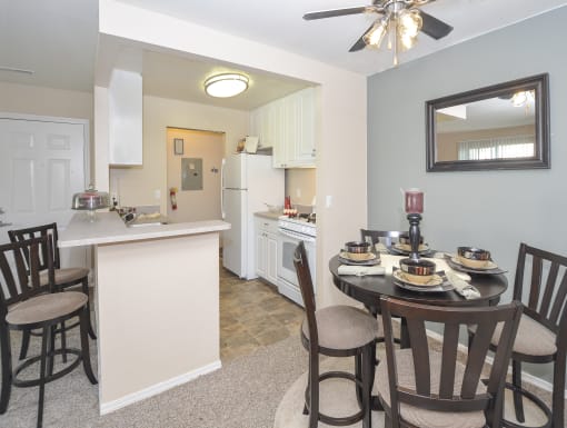 a dining room and kitchen with a dining table and chairs
