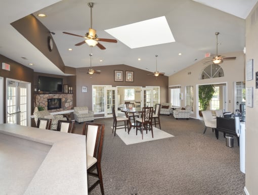 a large living room with a table and chairs and a fireplace