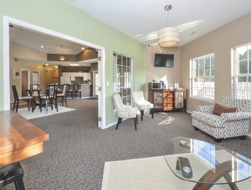 a living room and dining room with a table and chairs