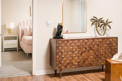 Room with a chair, table, and mirror at Southwind Apartments in Richland, MS.