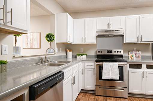 Stainless steel appliances and crisp white cabinetry in a Southwind Apartments kitchen in Richland, MS.