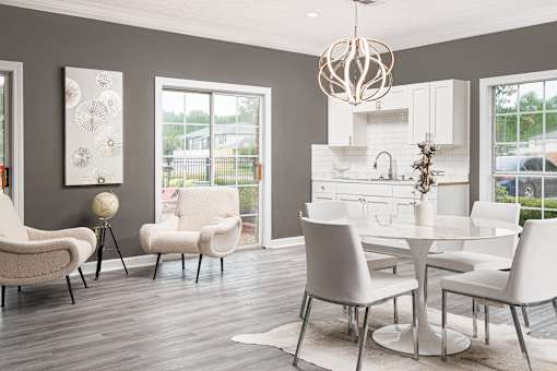 Modern dining area with white table and chairs at Southwind Apartments in Richland, MS.
