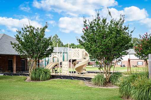 Community playground with slide at Southwind Apartments in Richland, MS.