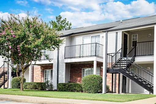 Apartment building exterior with grey facade and black metal staircase at Southwind Apartments in Richland, MS.