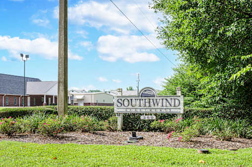 Southwind Apartments entrance sign in a landscaped garden in Richland, MS.