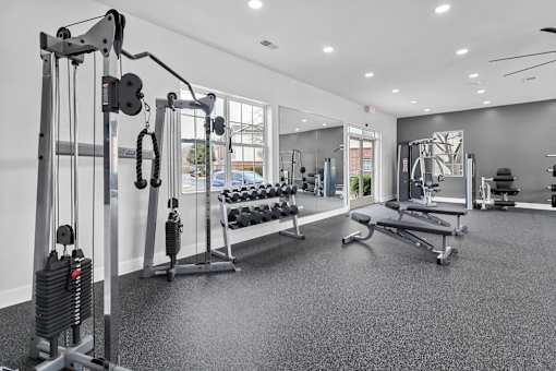 A gym with a variety of equipment including a leg press machine.