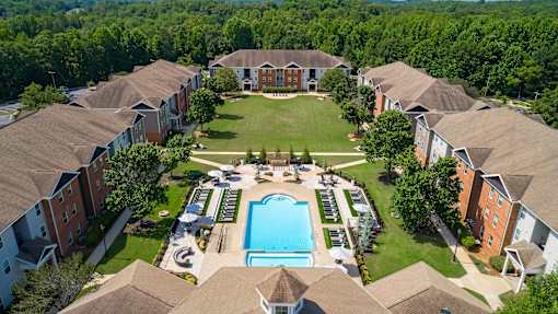 A bird's eye view of a community with a pool in the middle.