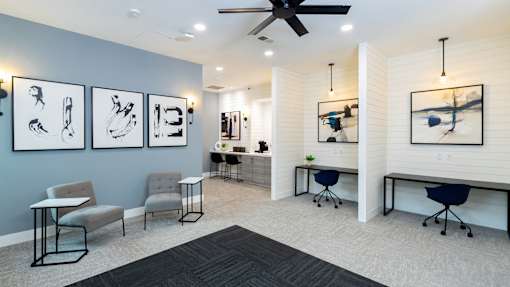 A room with a ceiling fan and a table with chairs.