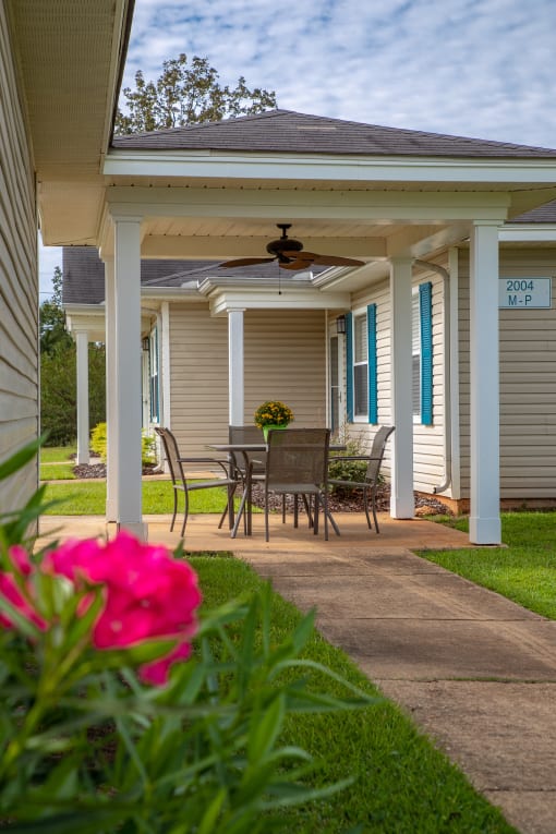 a patio with a table and chairs on it