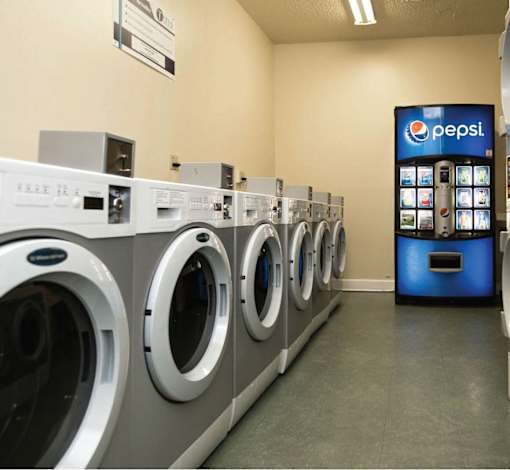 A row of washing machines in a laundromat.