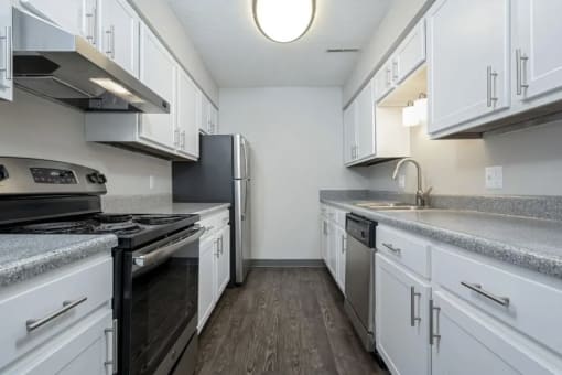 a kitchen with white cabinets and stainless steel appliances