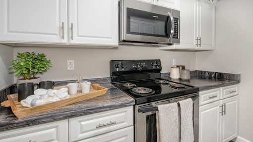 Kitchen with white cabinets and stainless oven at Atlas North Swartz Creek MI