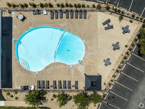 An aerial view of a swimming pool surrounded by lounge chairs.