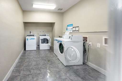On-site laundry room with washer and dryer at Cambury Hills Apartments in Omaha, Nebraska