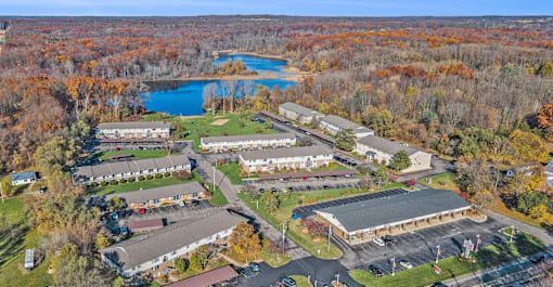 An aerial view of a large building complex surrounded by trees.