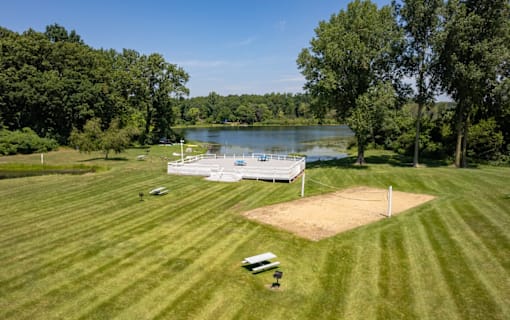 A baseball field with a lake in the background.