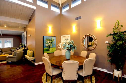 A dining room with a wooden table and chairs.