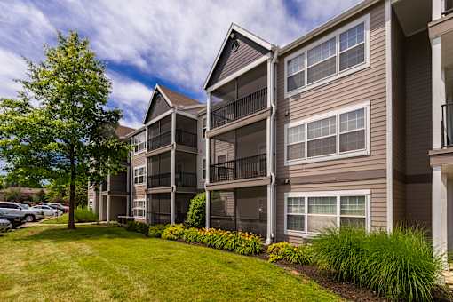 Apartment building with a green lawn in front.