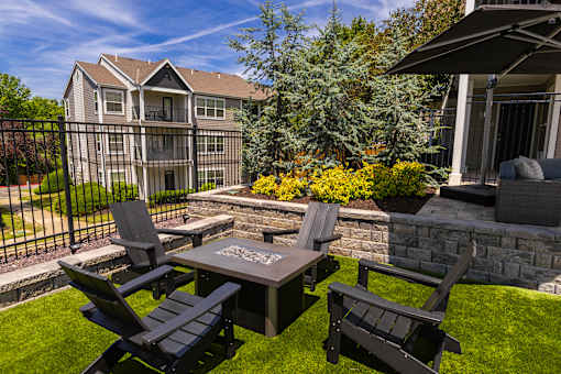 A backyard with a table and chairs.