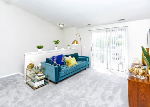 a living room with a blue couch and a table