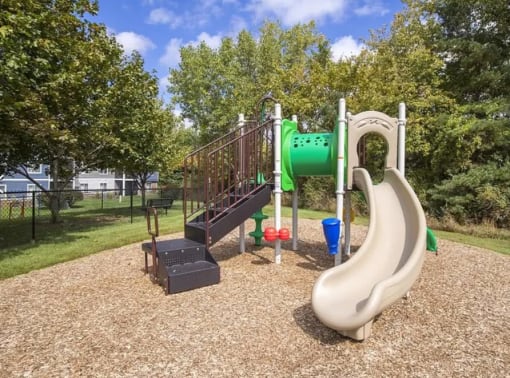 a playground with a slide at a park