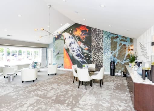 a dining room with a large wall mural and a table and chairs