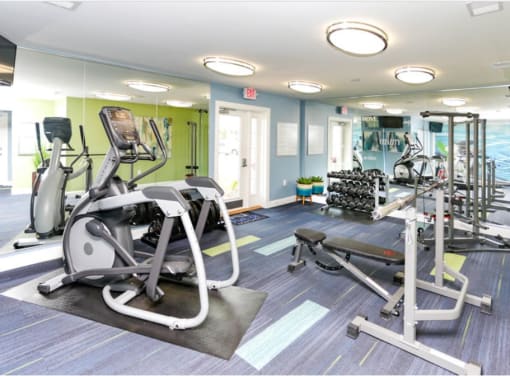 a gym with cardio equipment and weights at the monarch apartments in midtown