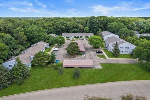 an aerial view of several houses and a parking lot