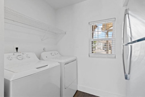 a white room with a washing machine and a window
