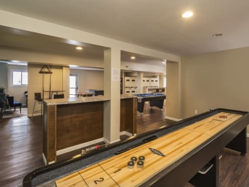 a basement with a pool table and a ping pong table