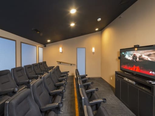 a room filled with black chairs and a flat screen tv