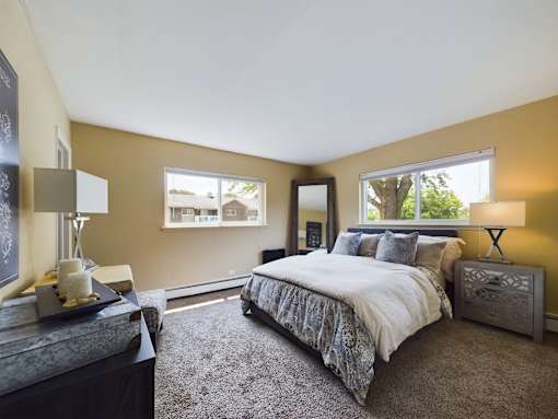 A bedroom with a large bed and a window.