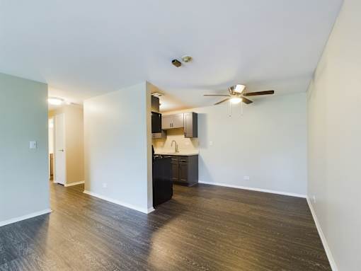 A kitchen area with a ceiling fan and a countertop.