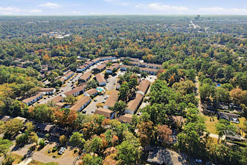 An aerial view of a residential area with houses and trees.