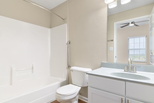 a bathroom with a sink toilet and a mirror