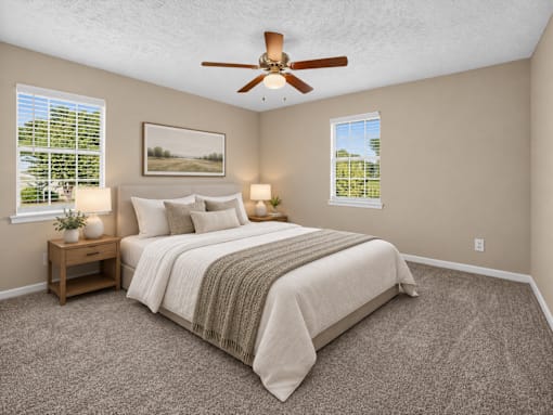 Bedroom with a bed, ceiling fan, and two lamps at Arbours at Victoria Place in Prattville, AL