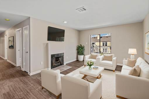 A living room with a fireplace and a flat screen TV mounted on the wall.