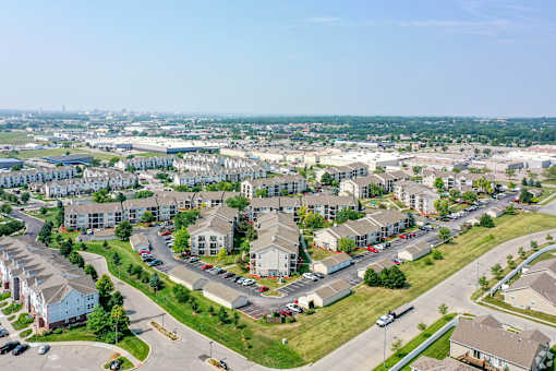 A suburban residential area with houses and parked cars.
