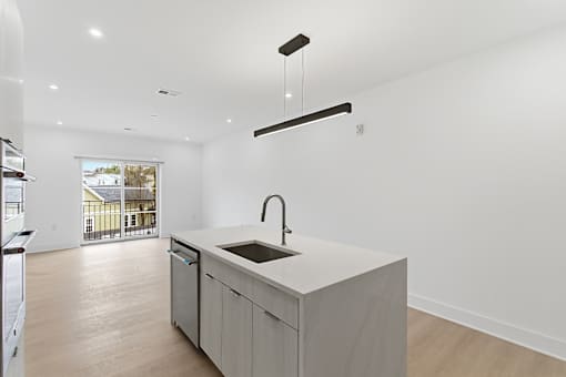 A modern kitchen with a sink and a window.
