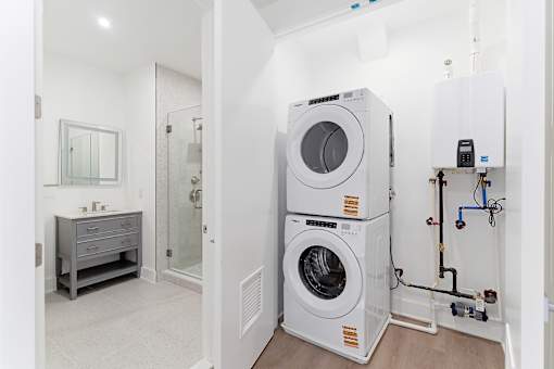 A laundry room with a washer and dryer stacked on top of each other.