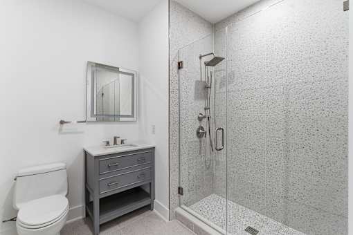 A bathroom with a toilet, sink, and shower.